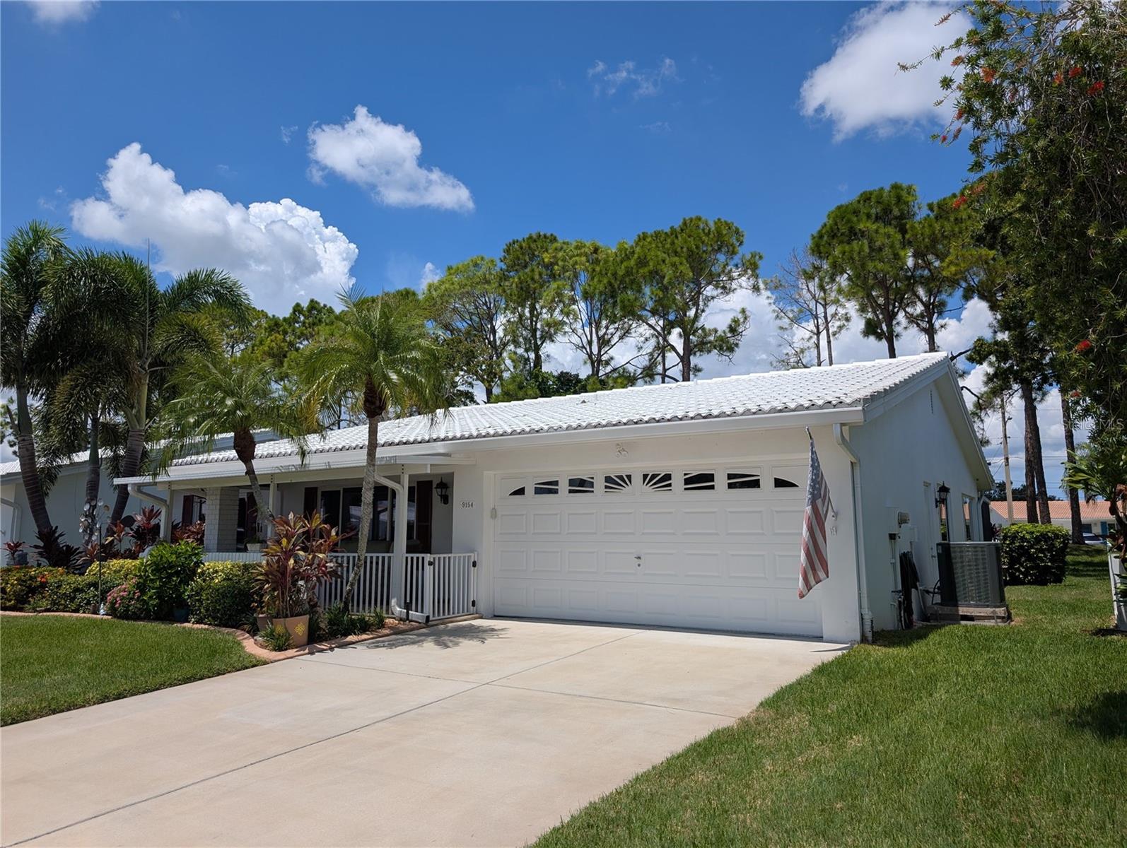 Exterior features include a two car garage, updated cement drive, tile roof, gutters, updated windows and a very nice lot...a little touch of the tropics in the front and a bit of rustic in the back.