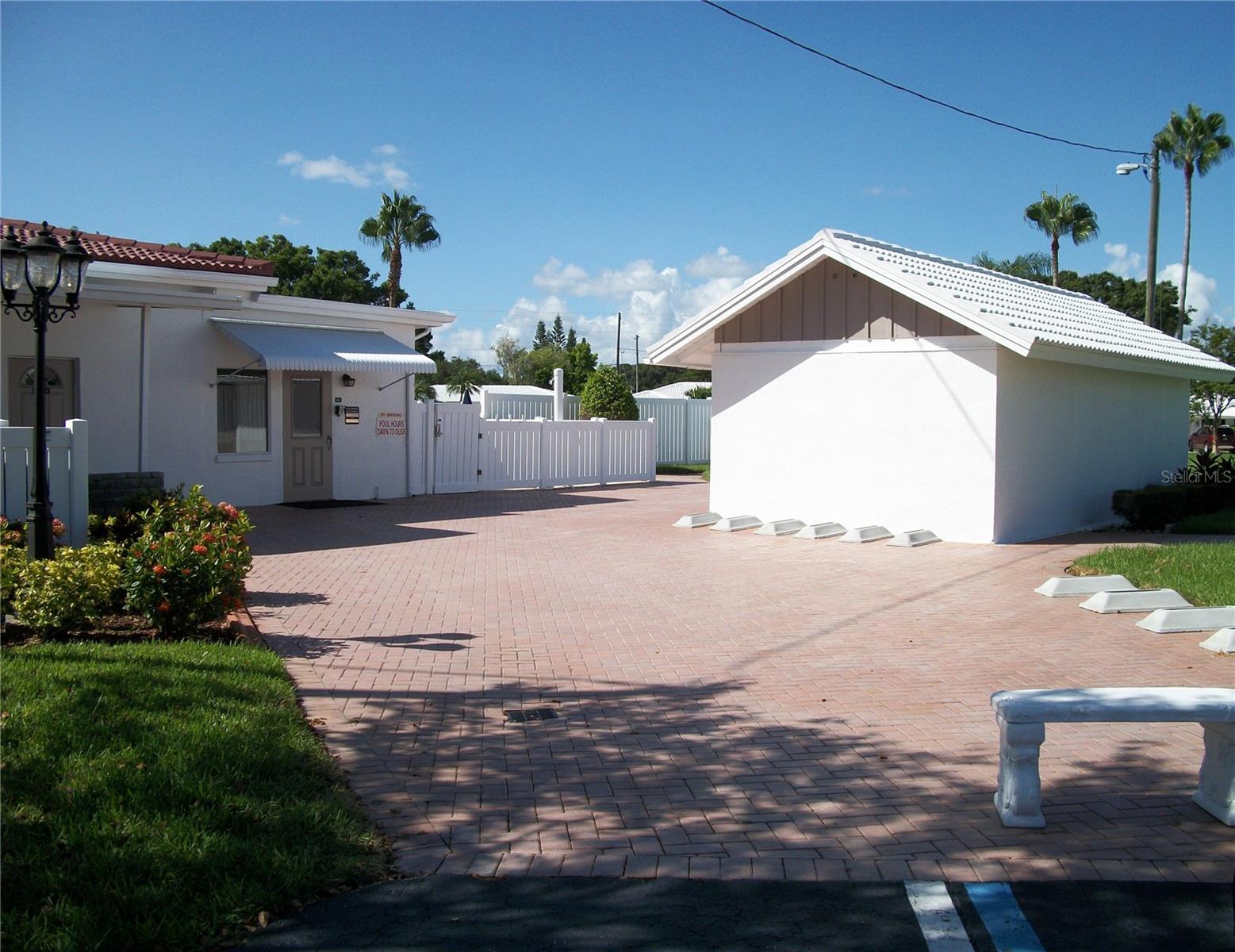 Golf cart and bicycle parking for residents.  A gated pool area with privacy fence is located on back side of the clubhouse.