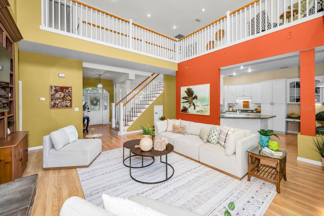 Looking into the kitchen, up into the loft, and the dining room on the other side of the staircase.