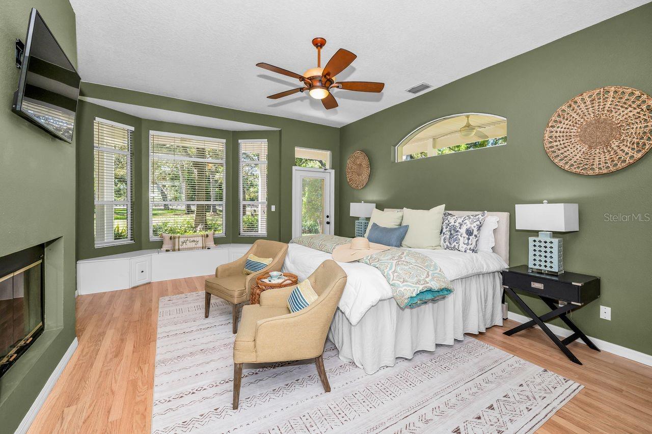 This stunning and spacious primary bedroom offers an incredible view of the property, a double-sided fireplace, an outdoor seating area, and access to the incredible primary bathroom and closets.