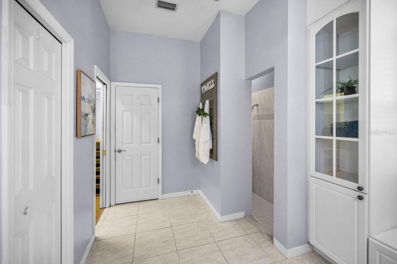 Large linen closet to the left, then an incredible walk-in closet, private toilet room, with the walk-in shower to the right.