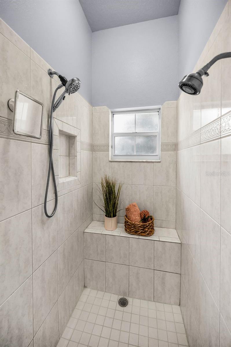 Spacious and well lit shower area.