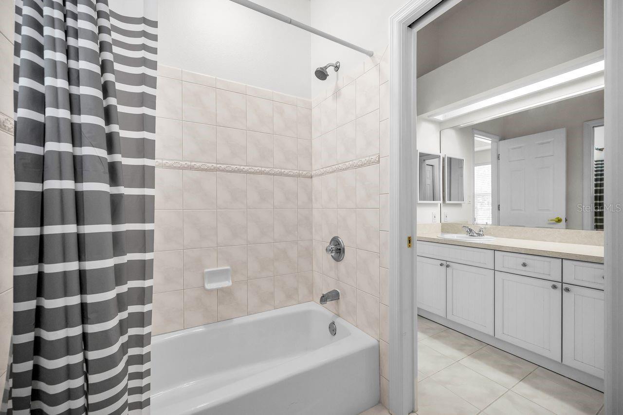 Bathroom features a separate room for the bathtub.