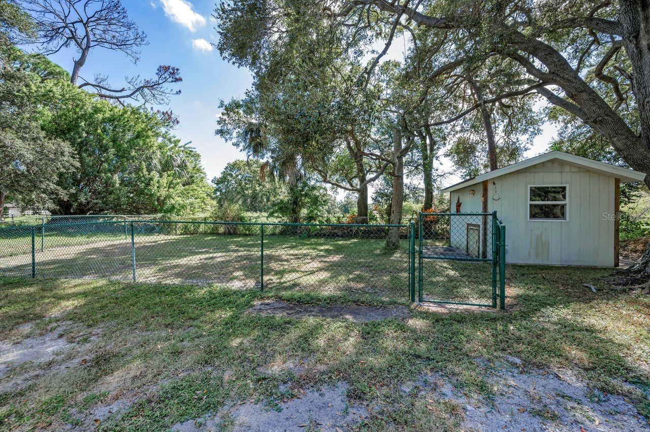This out building has ac and heat - great for a kennel or chicken coop and is completely fenced.