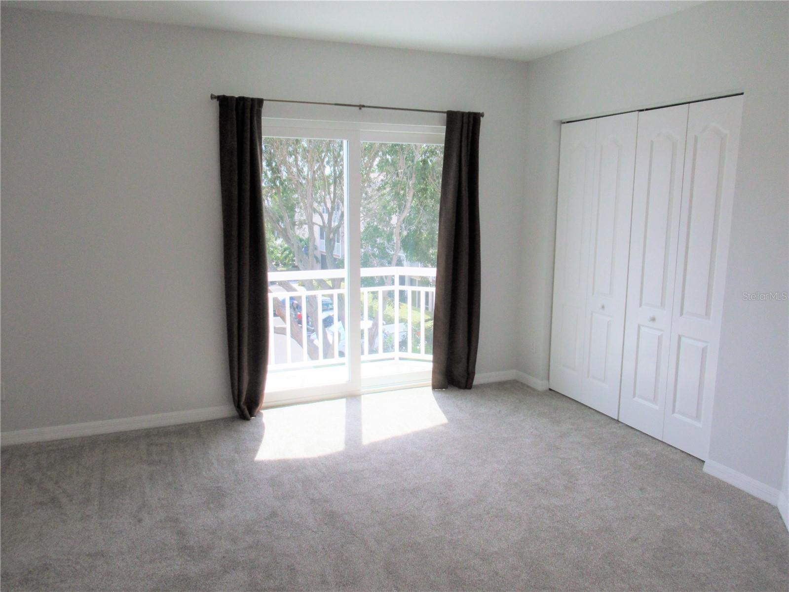 Bedroom #2 has newer impact patio doors and en-suite bathroom