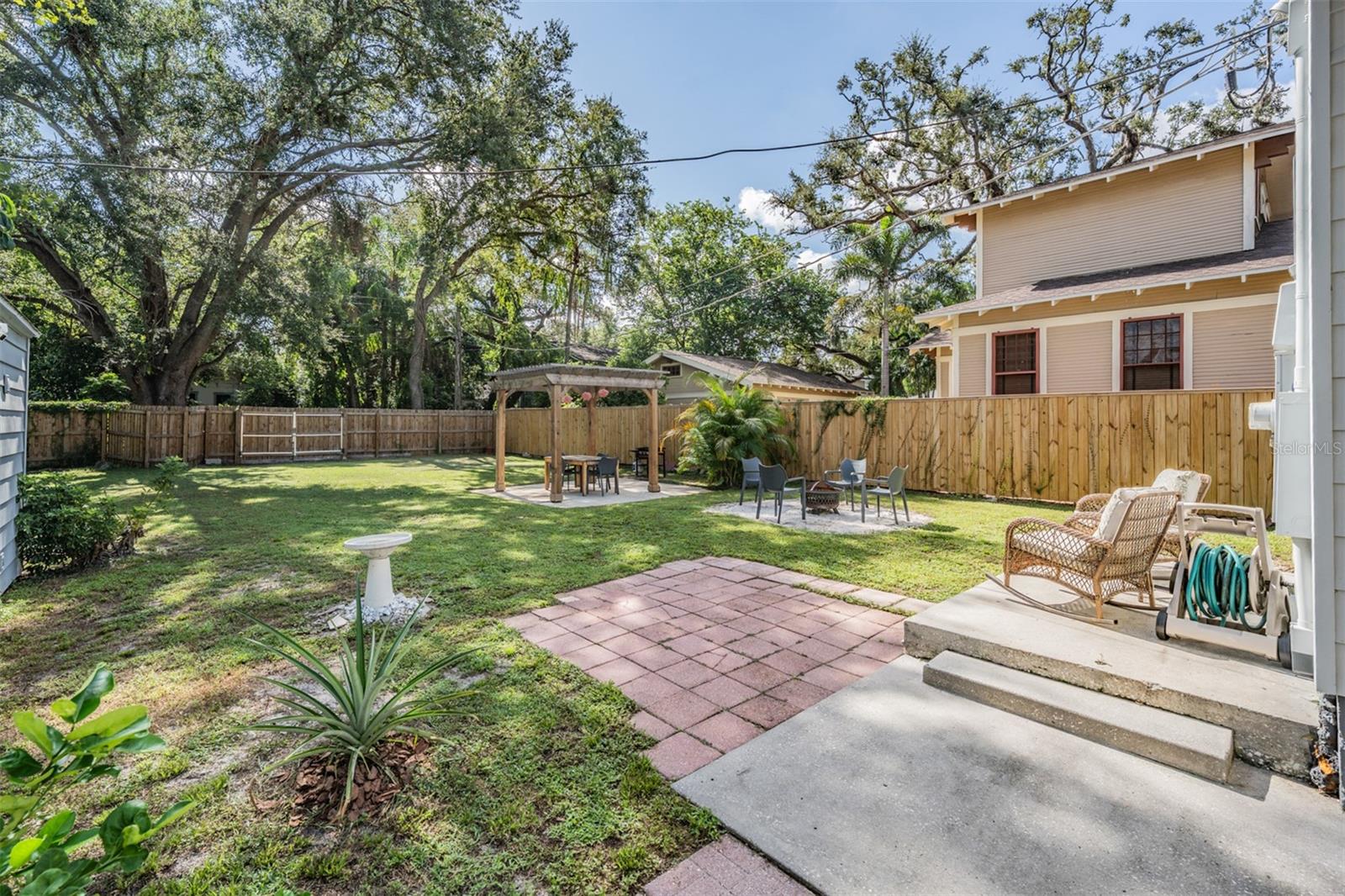 Gorgeous oversized backyard with custom pergola and fire pit area