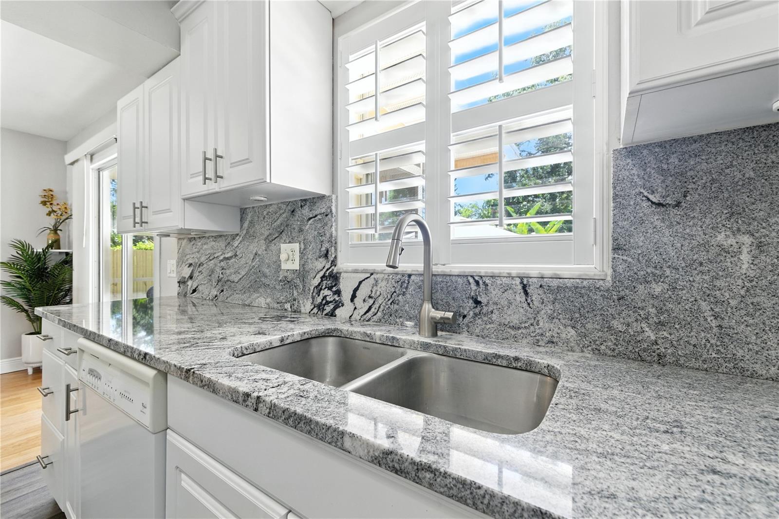 Kitchen sink, Plantation shutters overlooking backyard