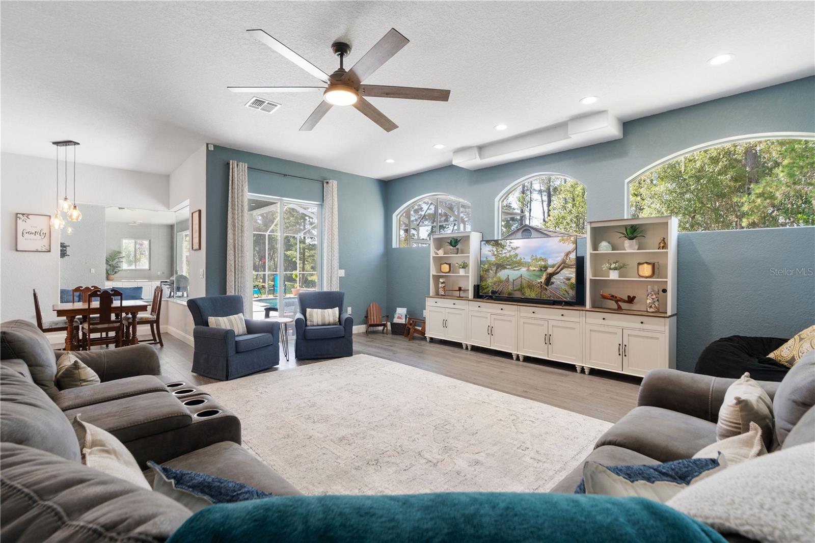 Sliding glass doors in the living room lead out to the lanai and pool.