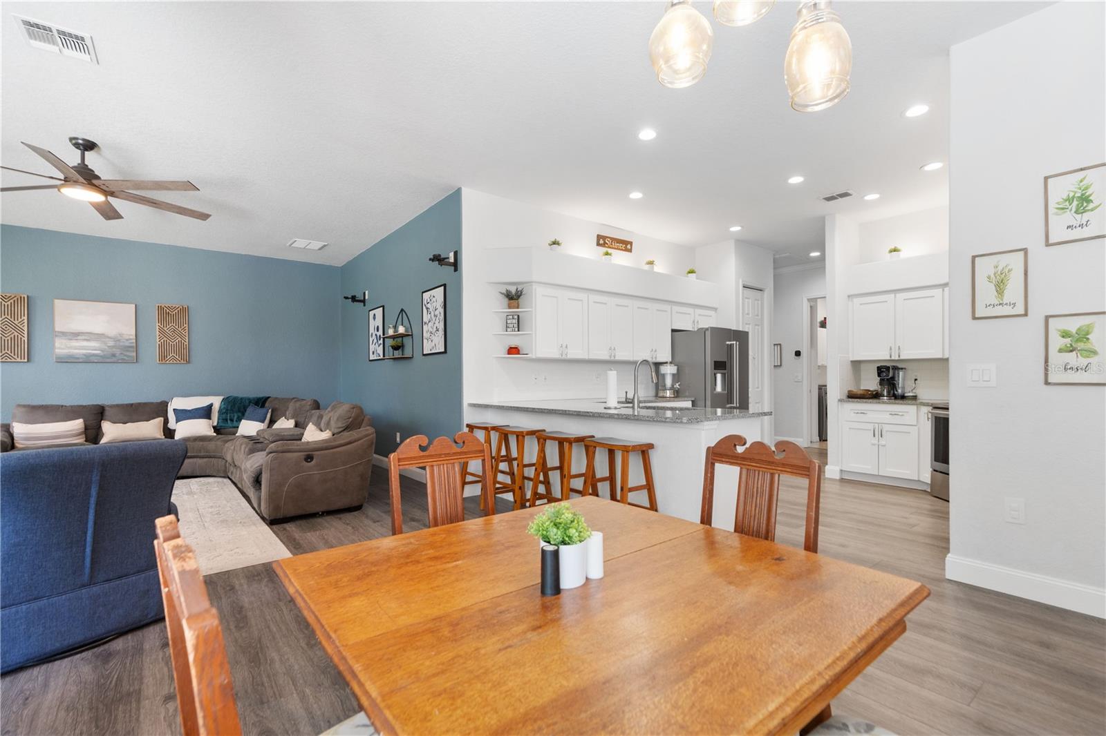 At the breakfast nook looking toward the kitchen which has plenty of recessed lights.