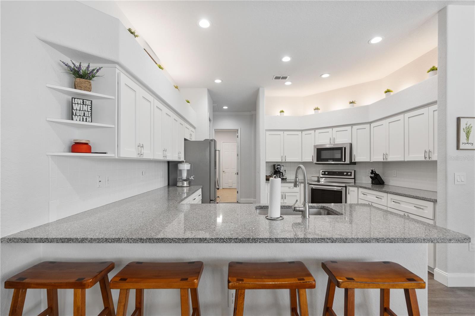 Plenty of cabinet space and room to move around in the kitchen. The kitchen is central to all rooms in the house. a direct shot to the utility room and garage.