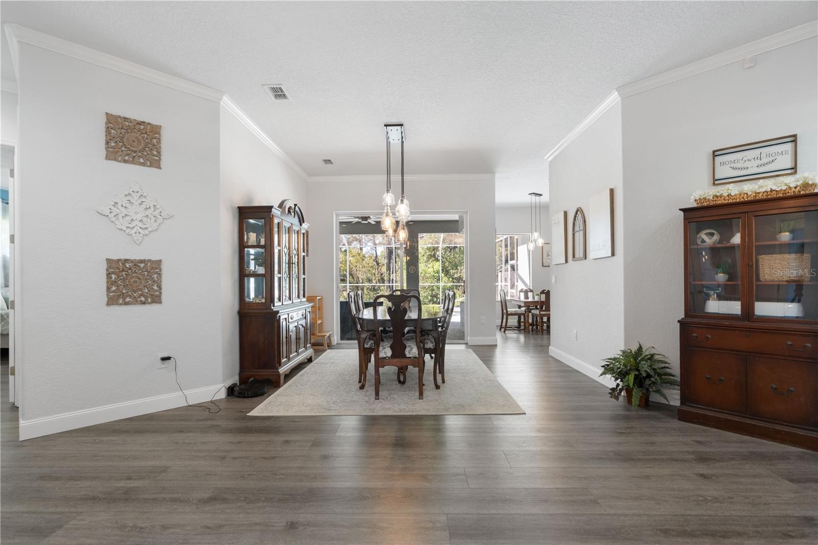 This room is being used as the formal dining area but could also be a formal living area. Hall to the left leads to Primary bedroom ensuite.