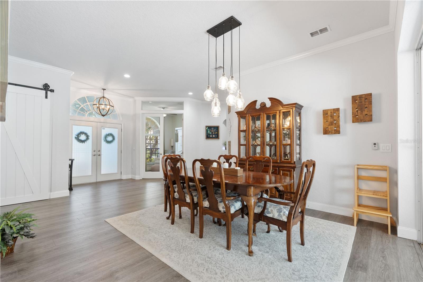 Barn door leads to bonus room, glass double doors on the right of the front entry doors is another bonus room with a closet