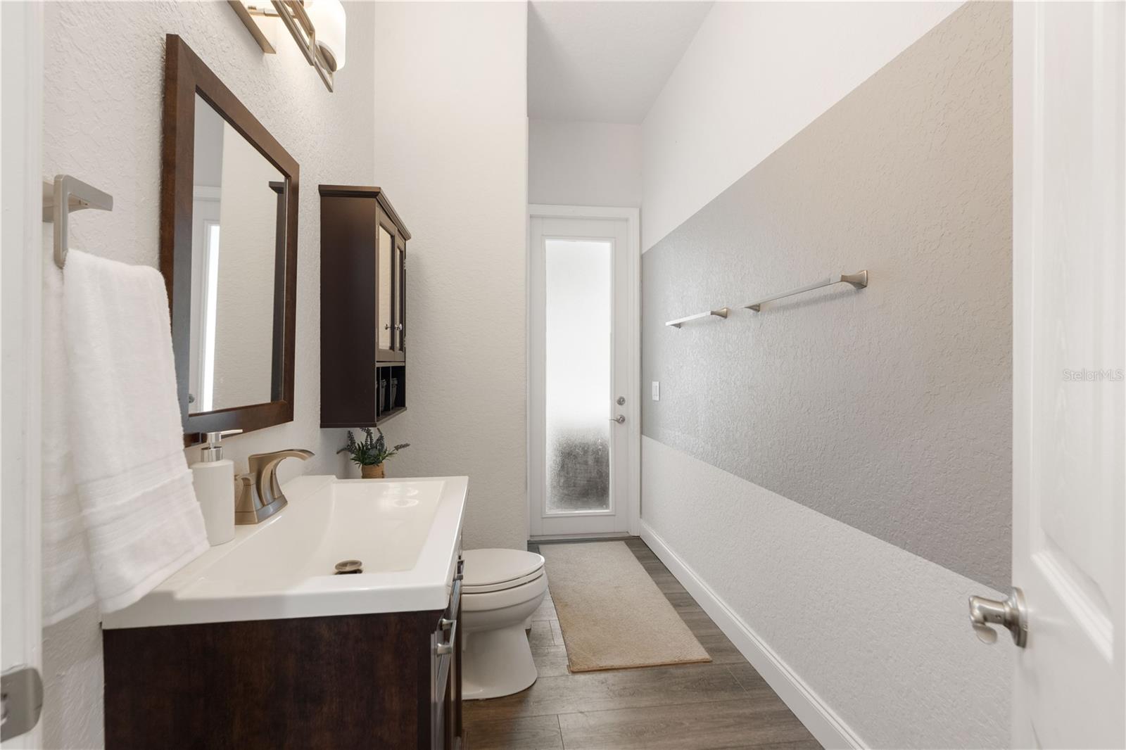 There is a linen closet to the left near the glass door.