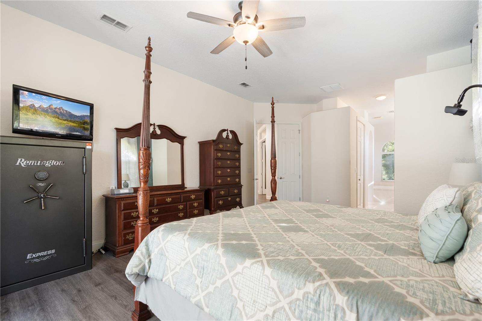 To the right of the bed are two closets and the entry way to the water closet, double vanity, tub and shower.