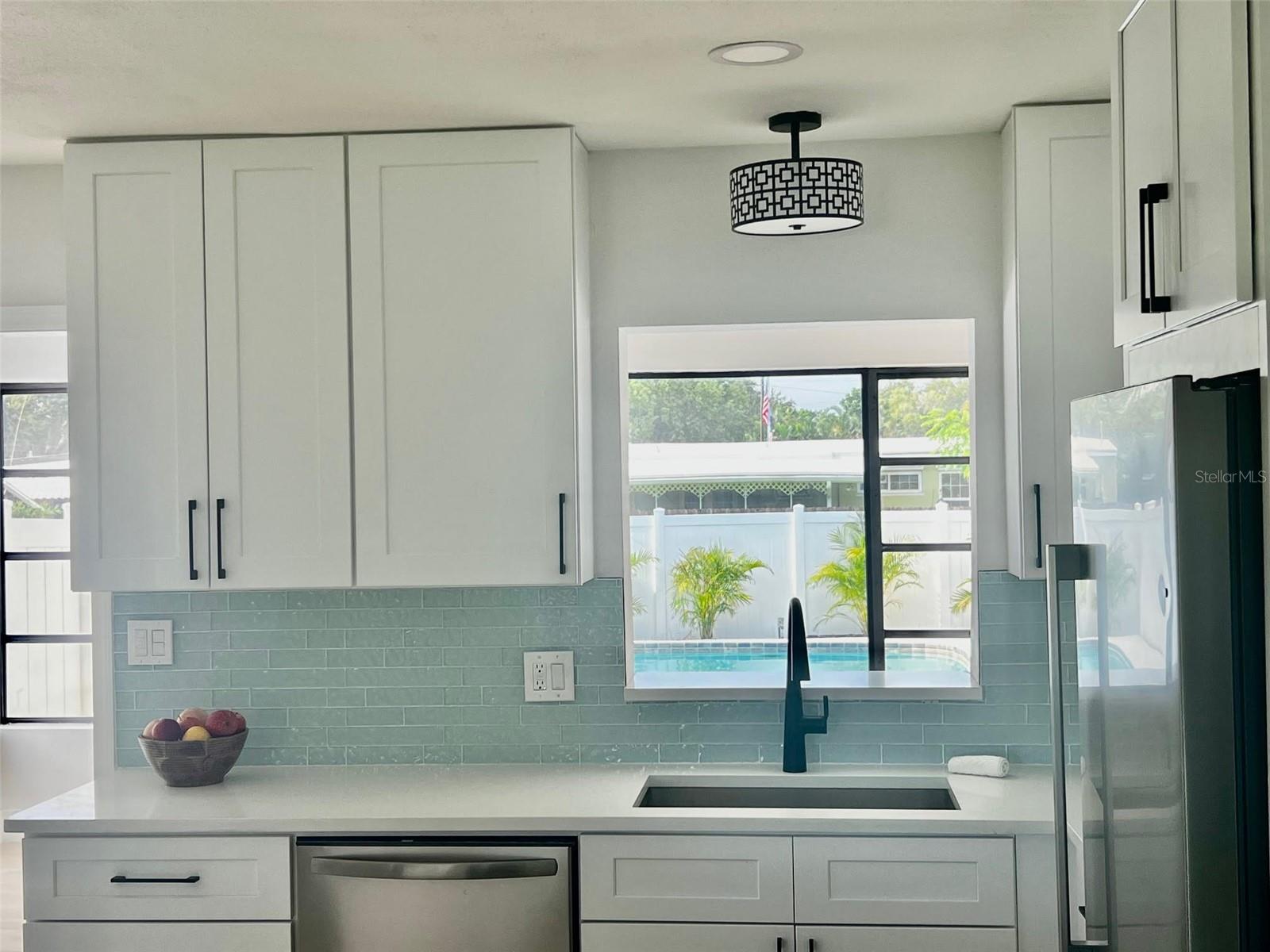 Sweet view of pool oasis from kitchen pass-through!