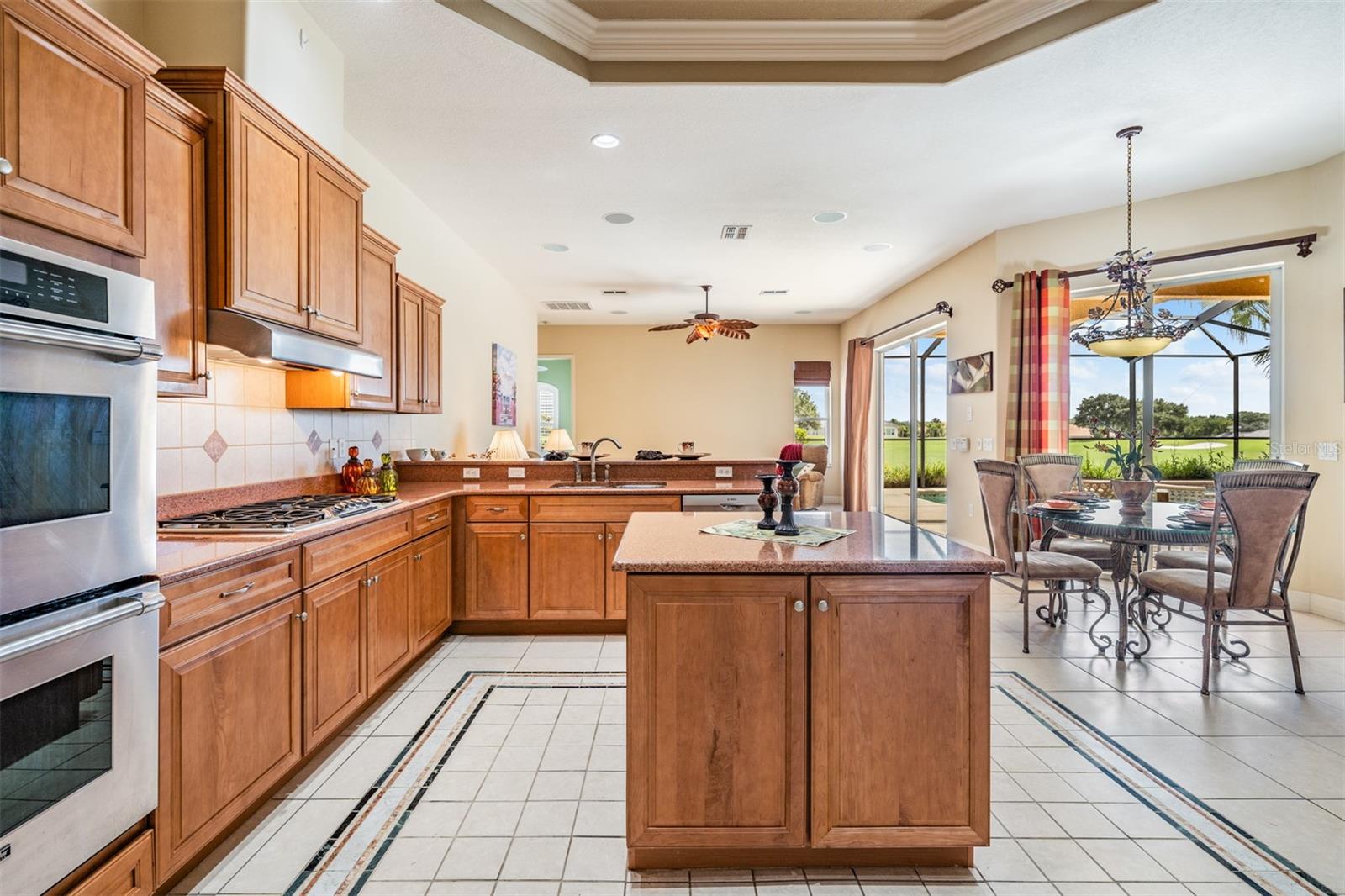 Lots of cabinets and workspace with tray ceiling