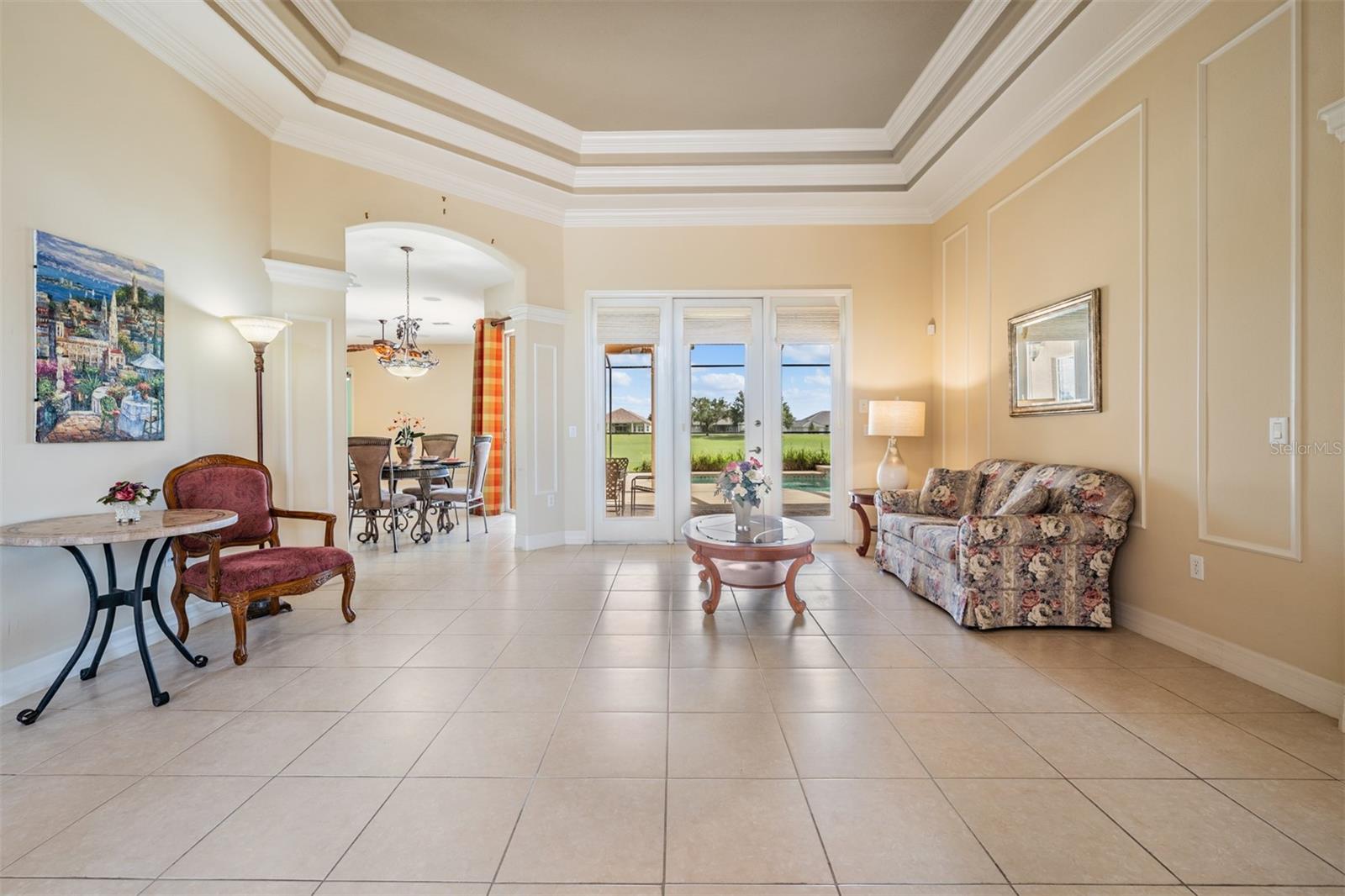 Formal living room with triple tray ceiling at the front of the home