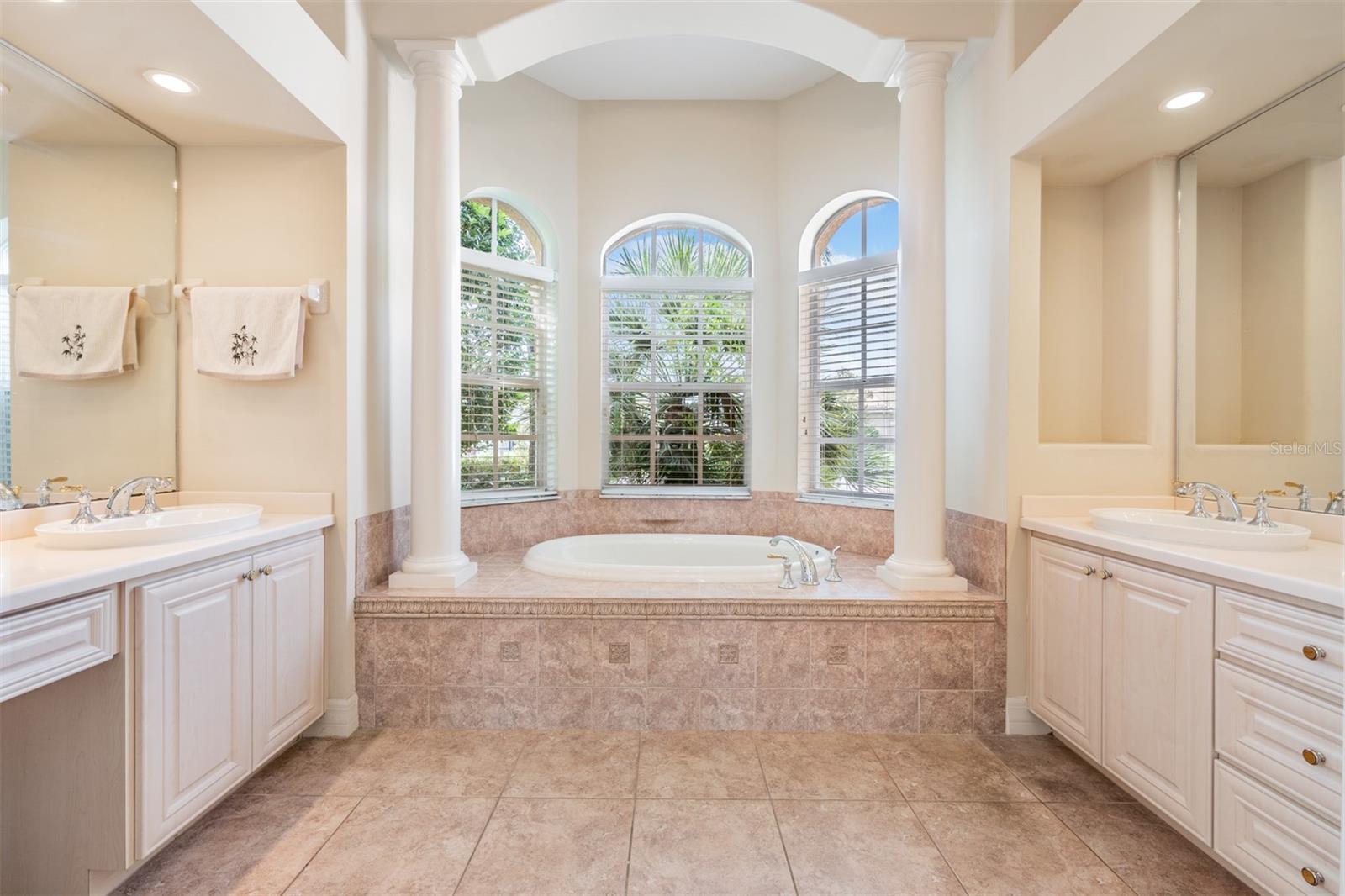 Columns adorn the soaking tub in primary bath ensuite