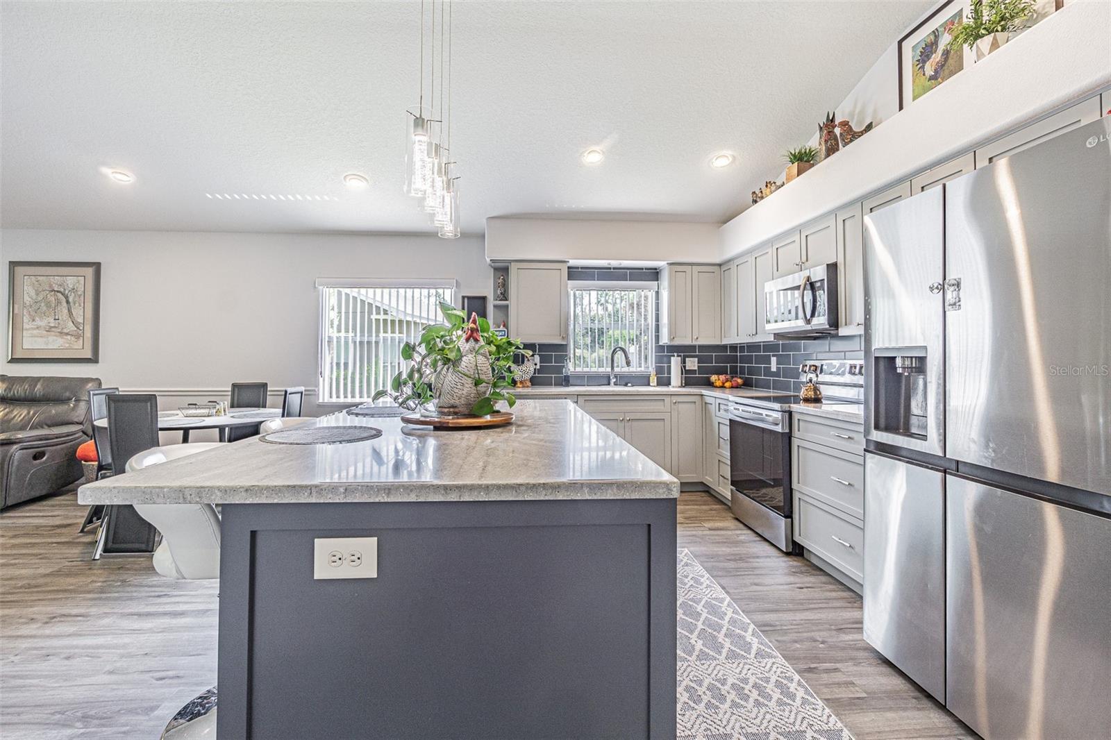Center island with breakfast bar in this renovated kitchen