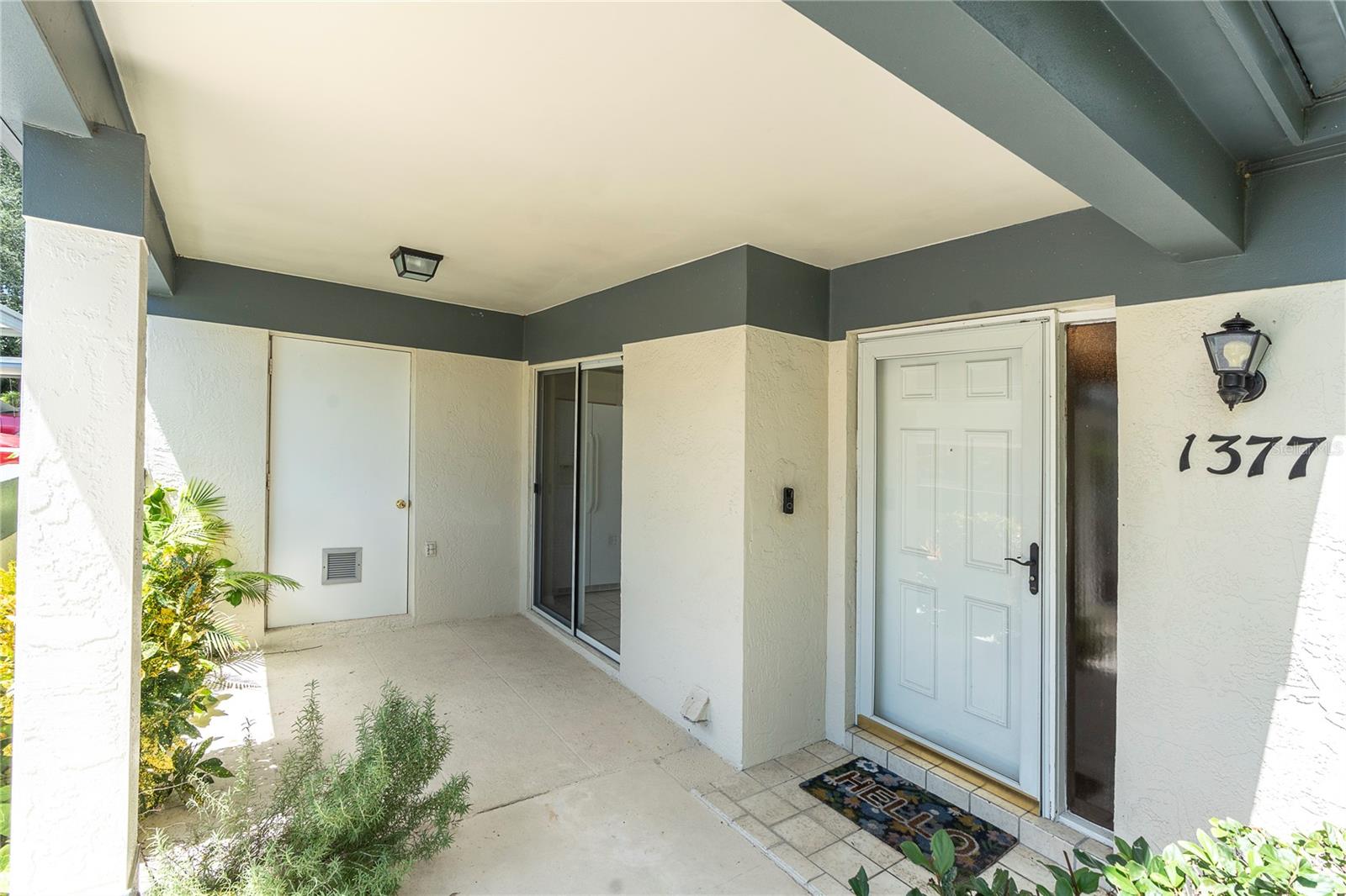 FRONT COURTYARD; SLIDER LEADS INTO KITCHEN; DOOR ON LEFT IS THE STORAGE AREA, ALSO HOUSES WATER HEATER; DOOR TO RIGHT IS FRONT ENTRY (1377 MCMULLEN BOOTH RD)
