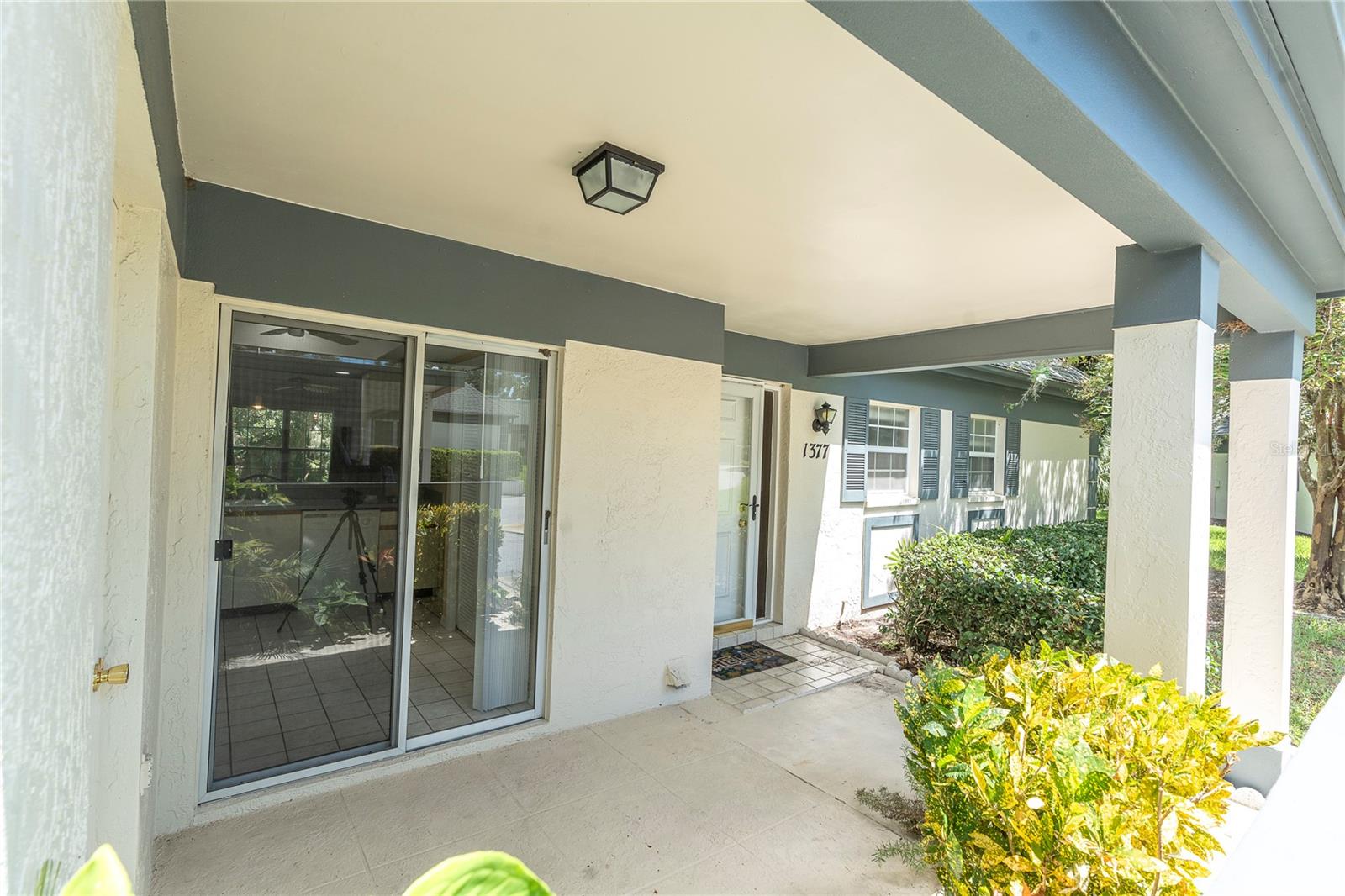 FRONT COURTYARD; KITCHEN IS ACCESSED THROUGH THOSE DOUBLE SLIDERS, AND THE FRONT DOOR IS TO THE RIGHT; YOU CAN'T SEE IT VERY WELL, BUT THE STORAGE AREA IS ON THE RIGHT  (1377 MCMULLEN BOOTH RD)