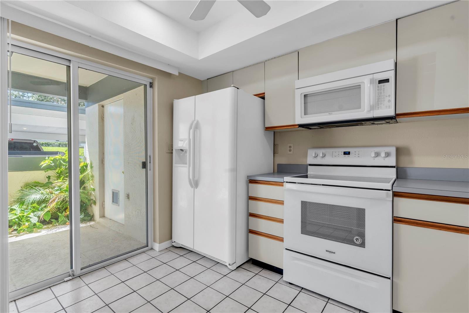 SLIDERS EXIT TO FRONT COURTYARD; STORAGE AREA IN BACKGROUND; ALL WHITE APPLIANCES, WONDERFUL NATURAL LIGHT  (1377 MCMULLEN BOOTH RD)
