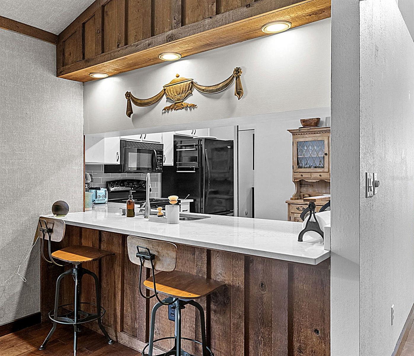Breakfast bar with view into kitchen