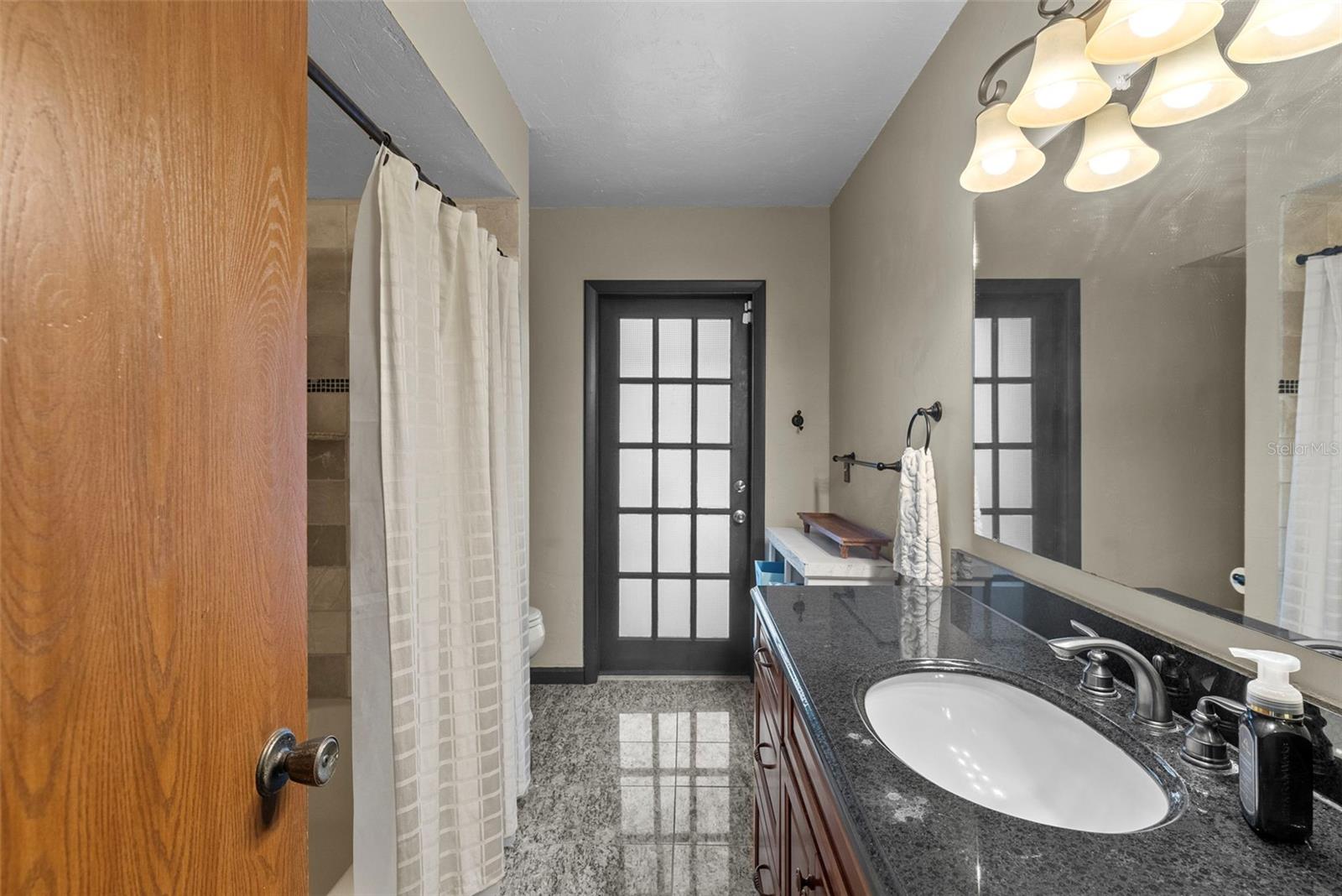 Updated full bath serving bedrooms two and three.