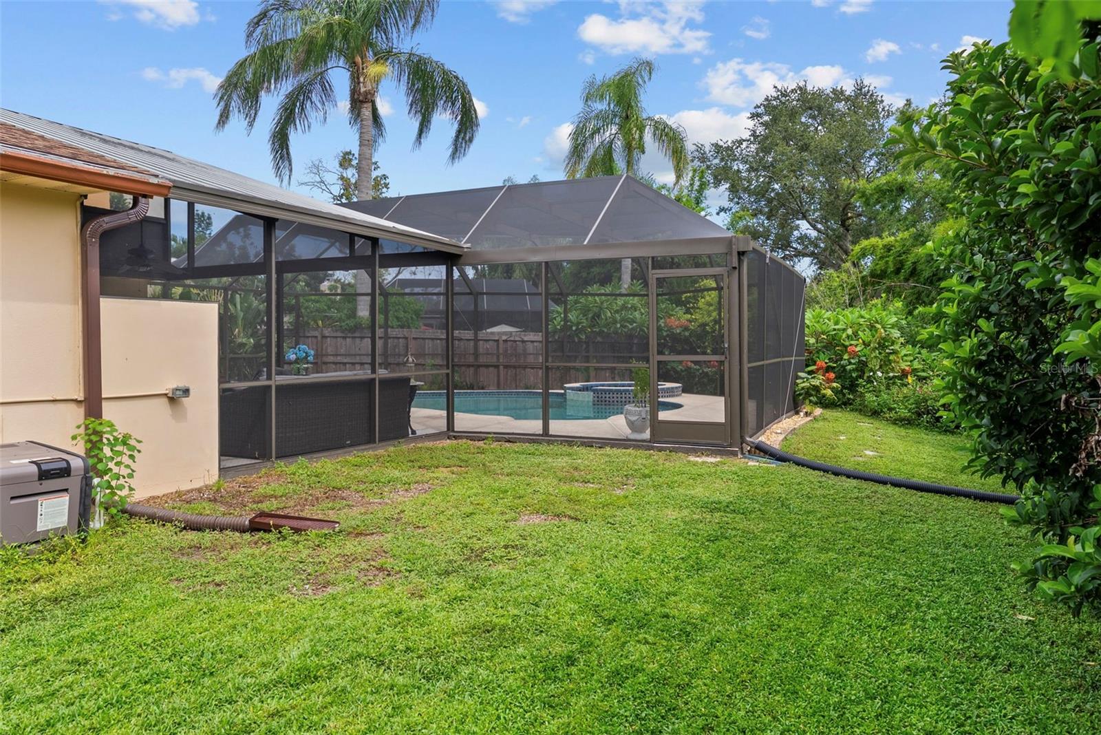 Oversized sideyard with plenty of green space for relaxation, pets, or play.