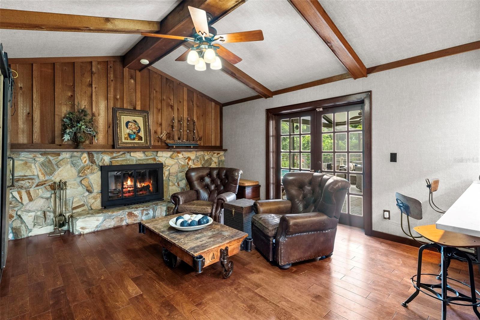 Bright and open family room with engineered maple wood floors (2018) and cozy wood-burning fireplace.