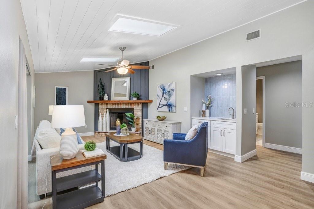 Family Room off of Kitchen Featuring a Wet Bar and Wood Burning Fireplace