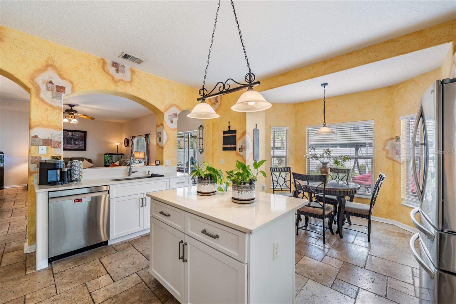 Updated Kitchen, Quartzite Counter Tops, Stainless Steel Appliances, Island for Storage, Tile Flooring.
