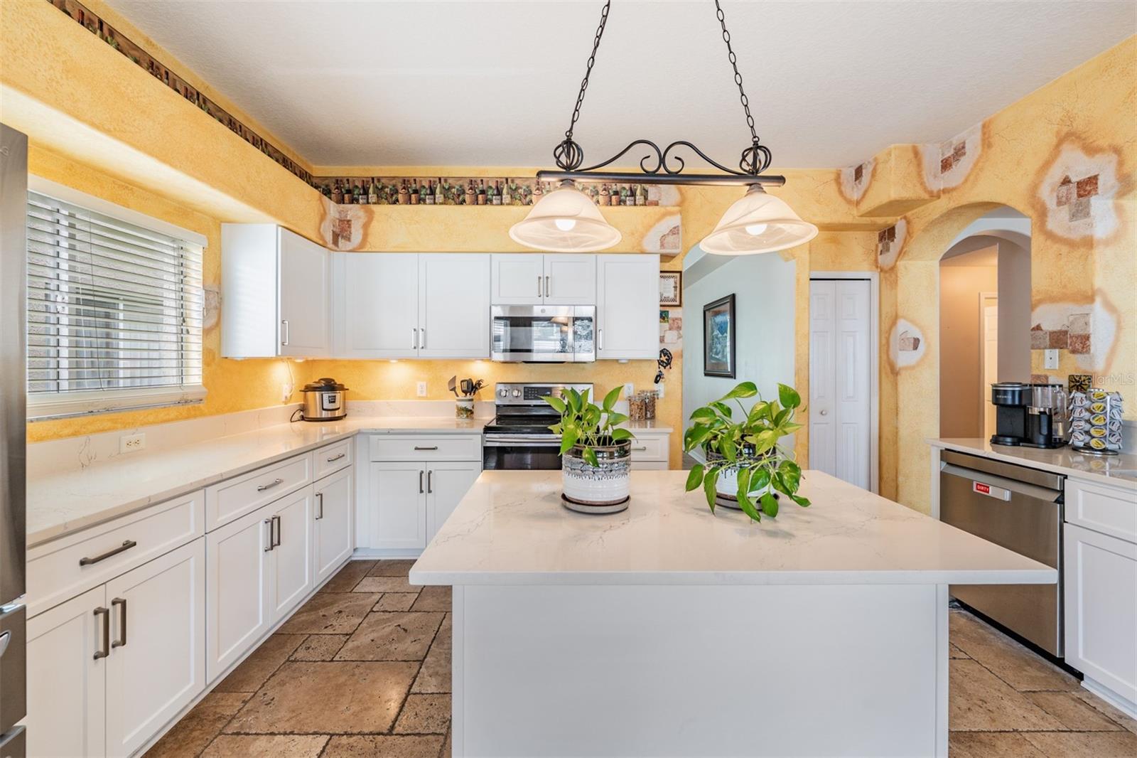 Updated Kitchen, Quartzite Counter Tops, Stainless Steel Appliances, Island for Storage, Tile Flooring.