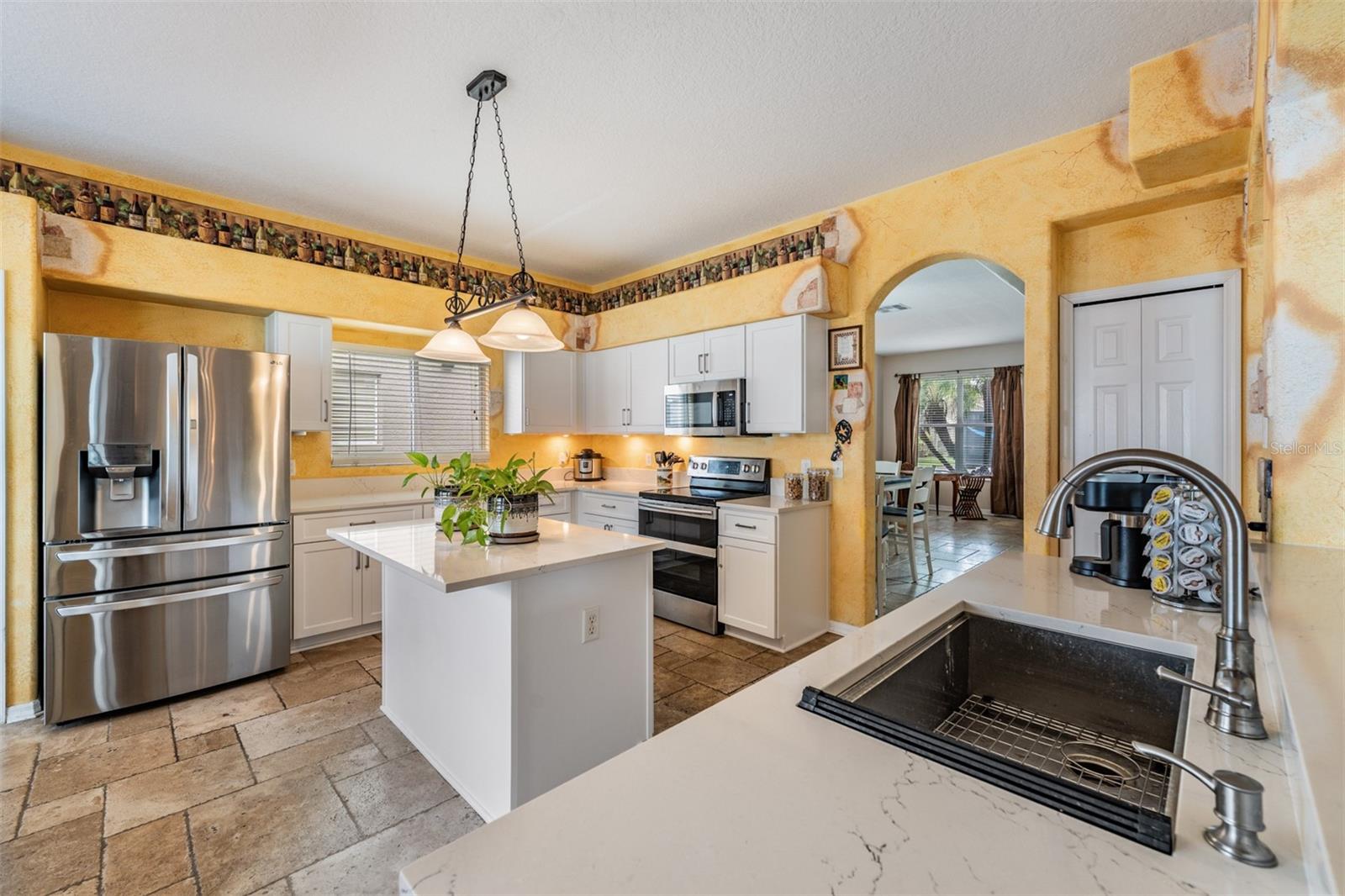 Updated Kitchen, Quartzite Counter Tops, Stainless Steel Appliances, Island for Storage, Tile Flooring.