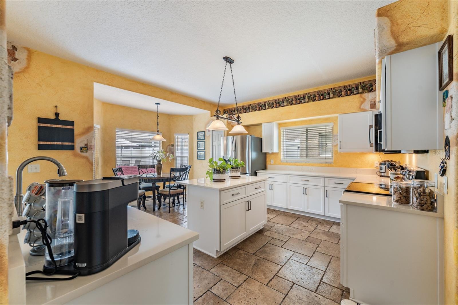 Updated Kitchen, Quartzite Counter Tops, Stainless Steel Appliances, Island for Storage, Tile Flooring.