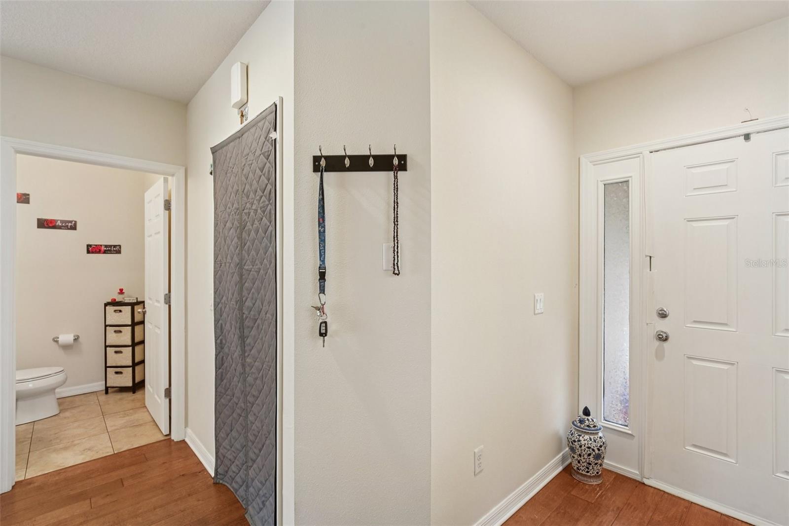 Gray Curtain Over Garage Entry Door.