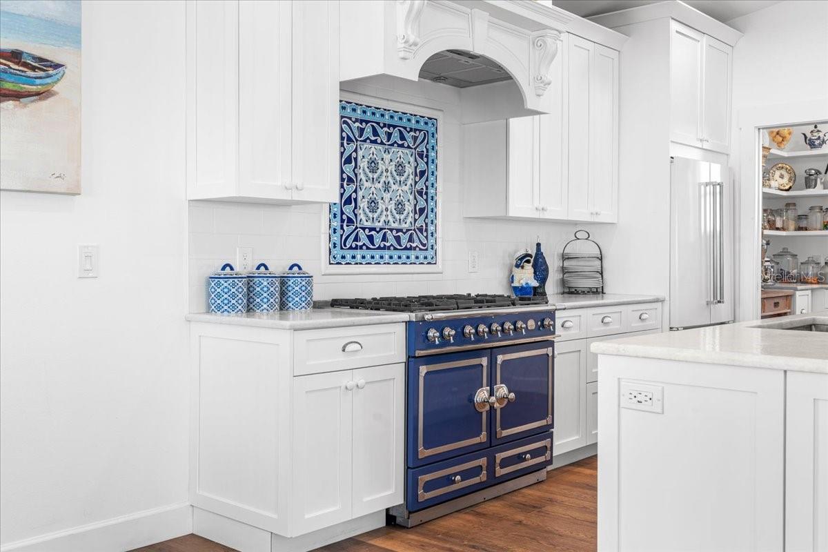 3rd Floor: High End Chef's Kitchen: La Cornue Gas Range, Designer Tiled Backsplash, "Pantry" Entrance next to Fridge, Pocket Door Versatility