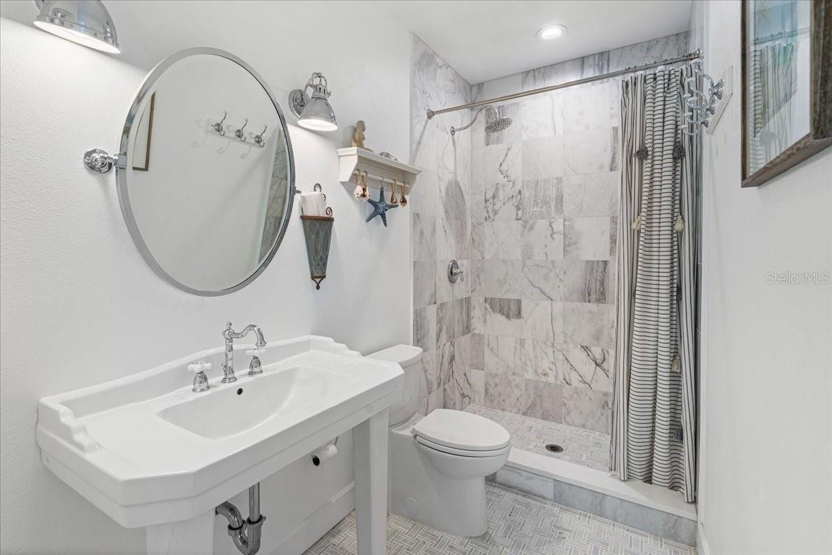 2nd Floor:  Second Bedroom's En Suite Bath. Marble Tile, Pedestal Sink, Linen Closet