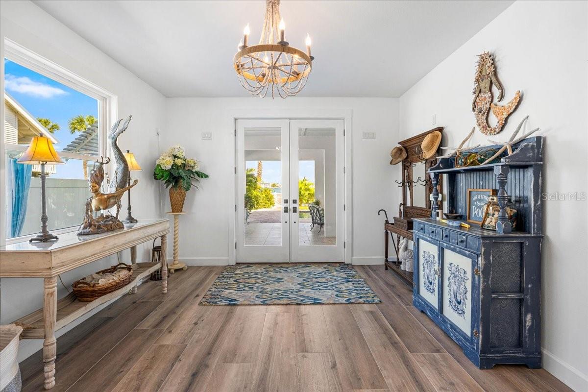 1st Floor:  Foyer, Hurricane rated Front Double Doors, Leads to Covered Patio and pool area.