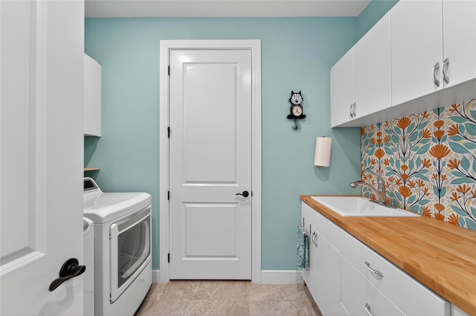 Laundry room with upper & lower cabinets