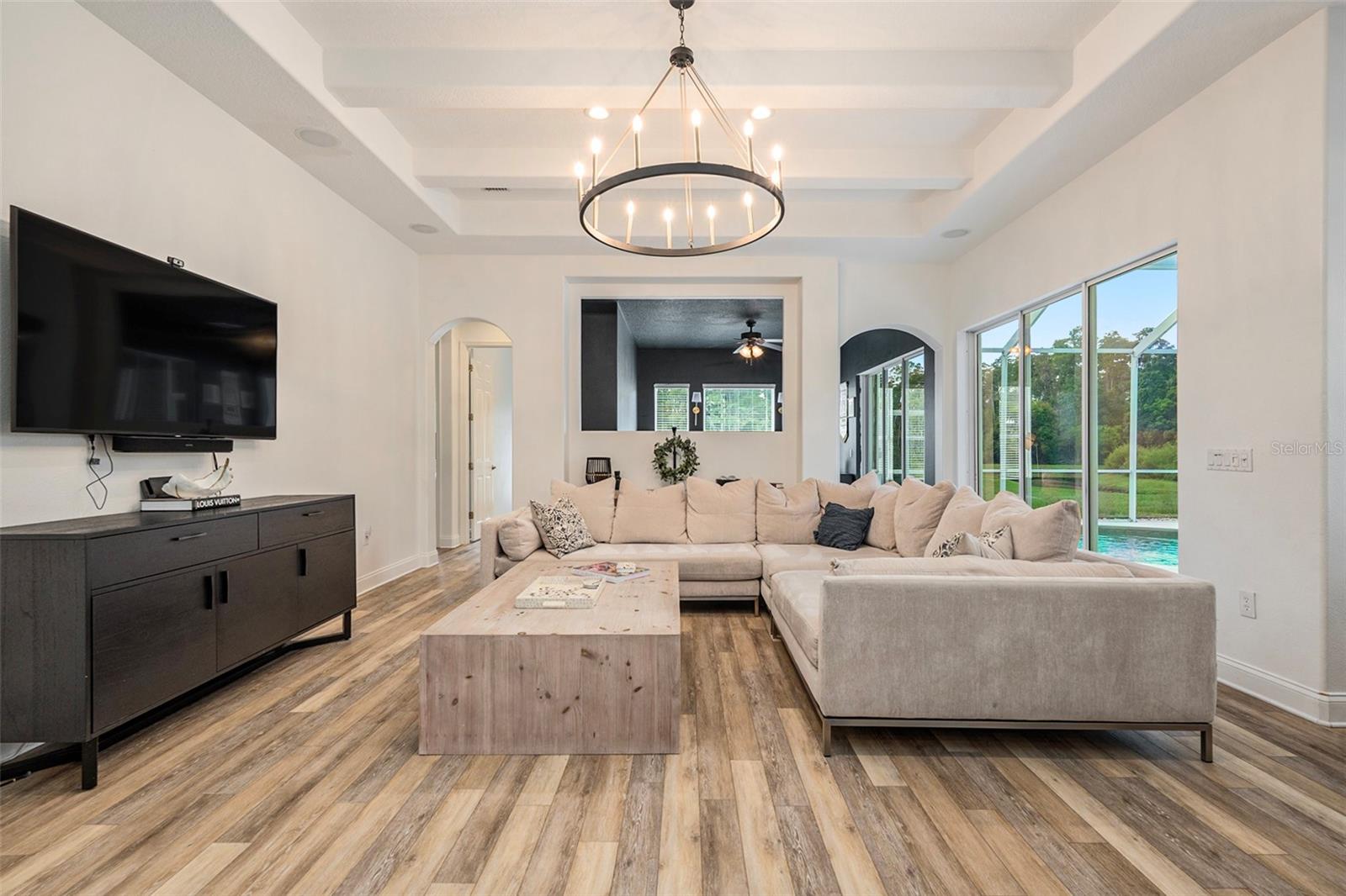 Family Room Showcasing New Upgraded Floors, Beams, and High Ceilings