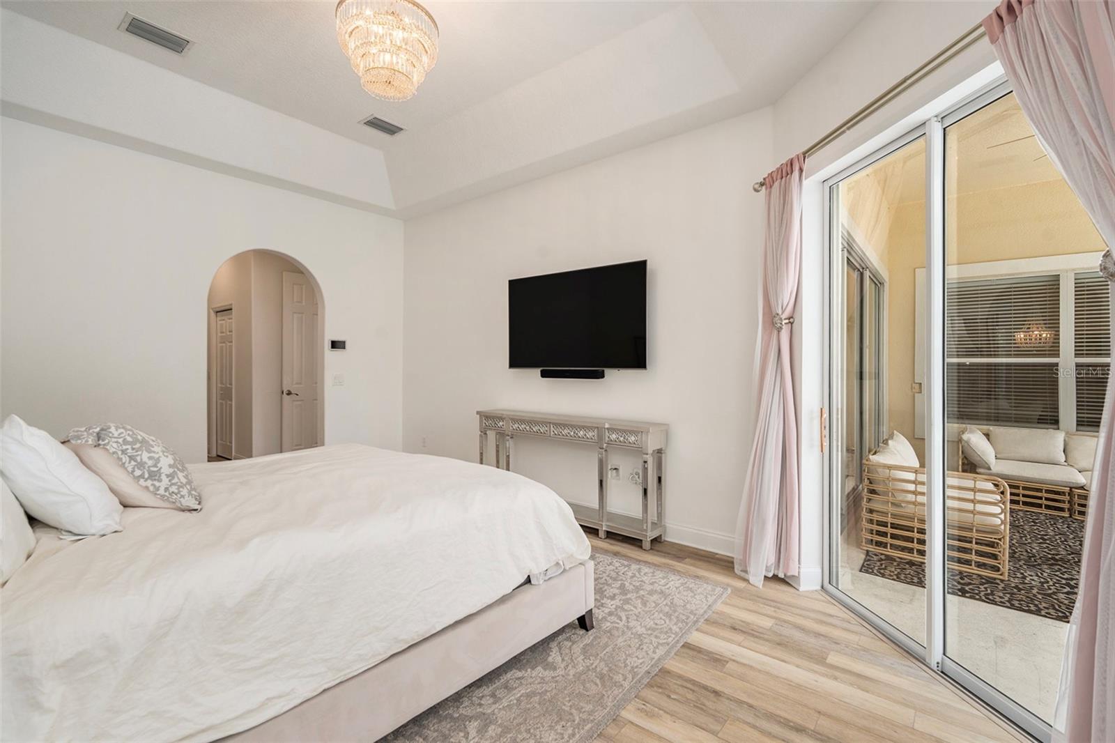 Primary Bedroom with View of Pool, Double Walk-in Closets, and Large En Suite Bathroom