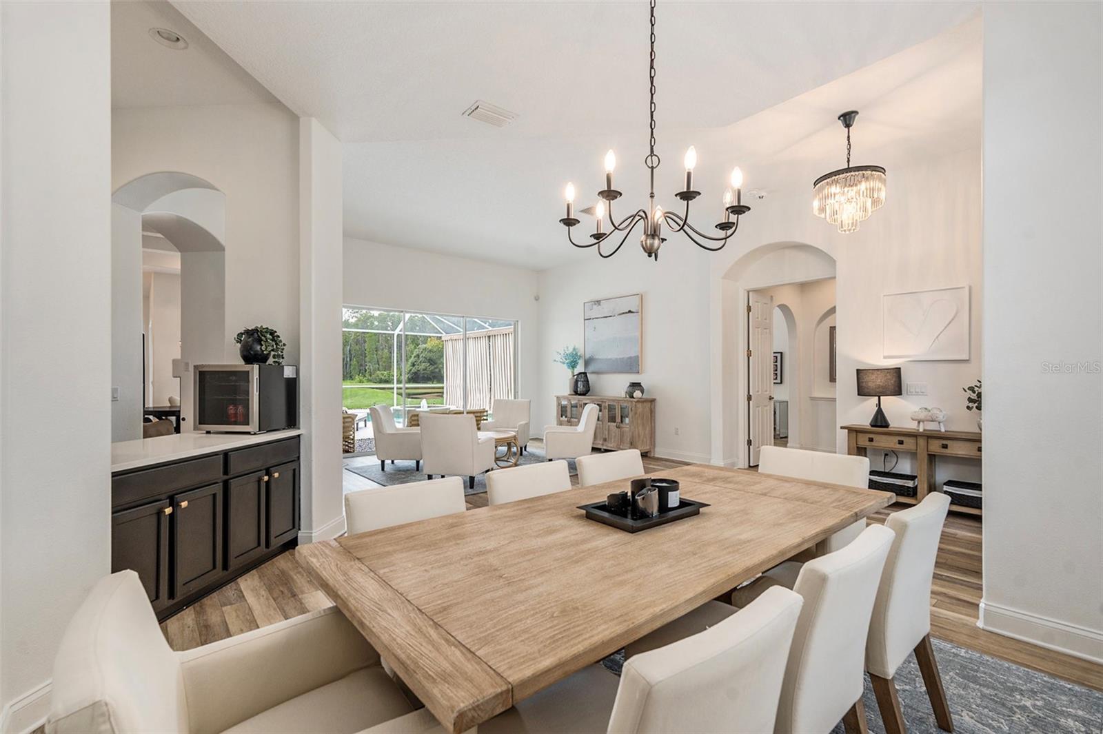 Dining Room into Wet Bar and Living Room and Pool
