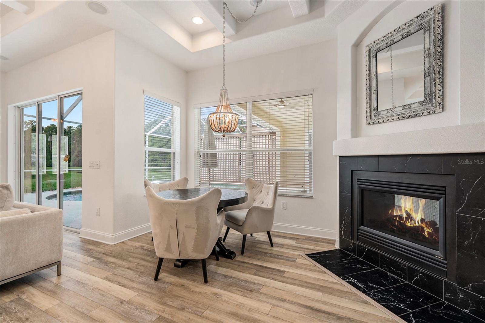 Breakfast Nook with Double Sided Fireplace and Another View of the Pool