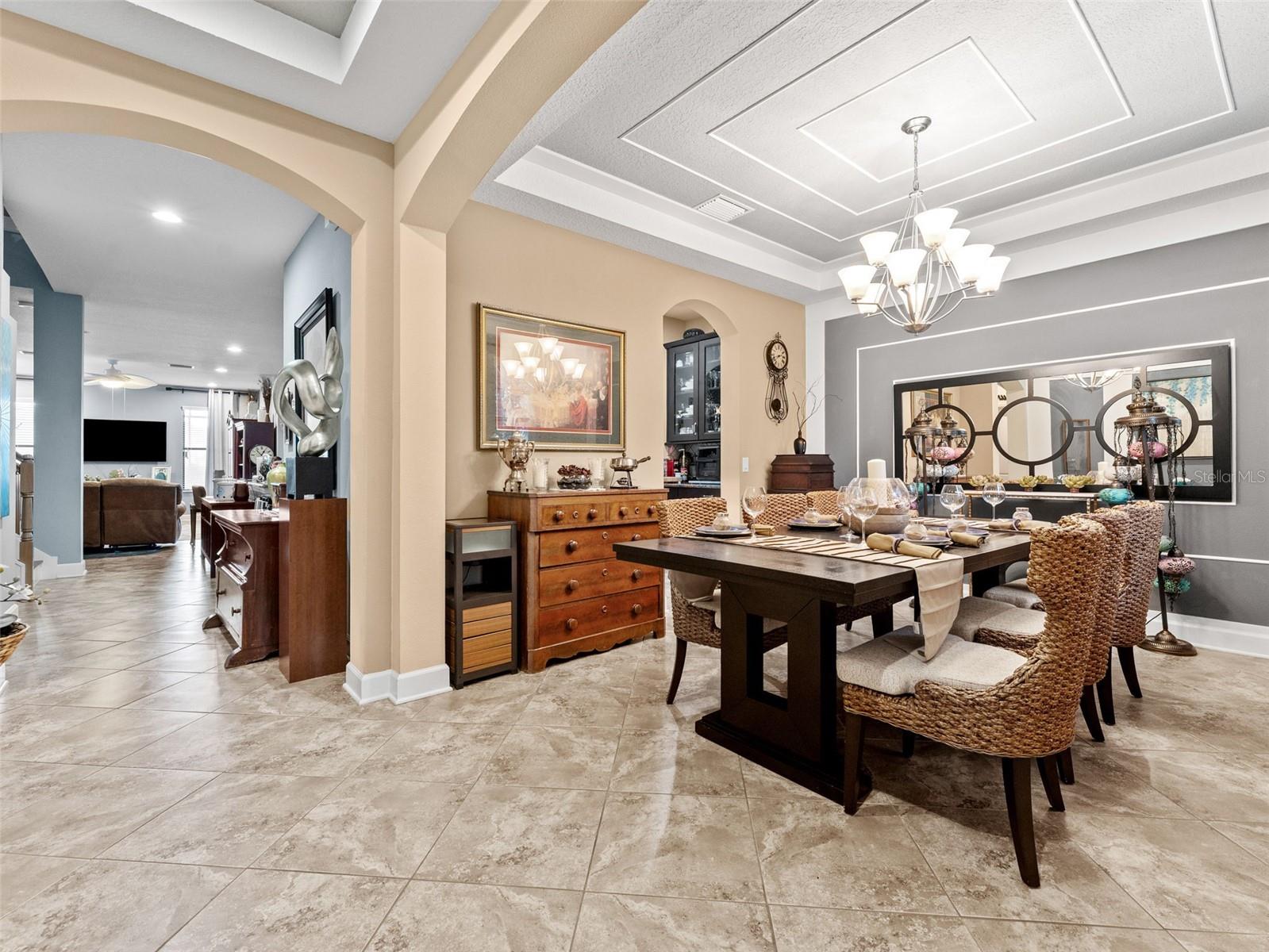 Wide entryway into formal dining room and family room... look at those ceilings!