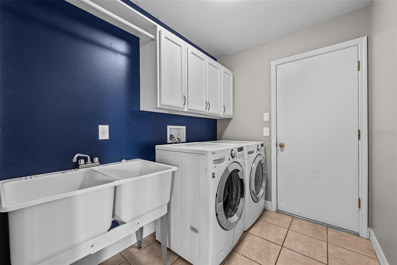 Laundry Room with sink and cabinets from 3 car garage