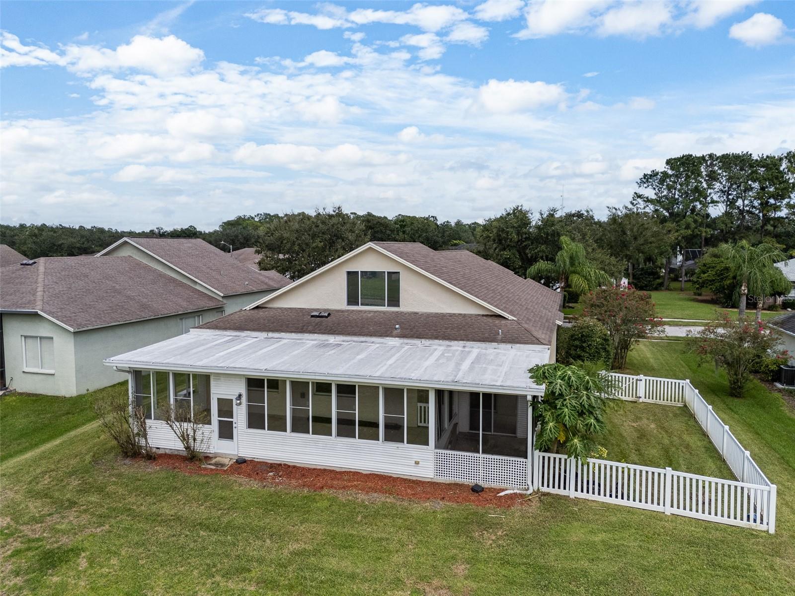 Florida room plus covered screened in lanai overlooks golf course and has side yard.
