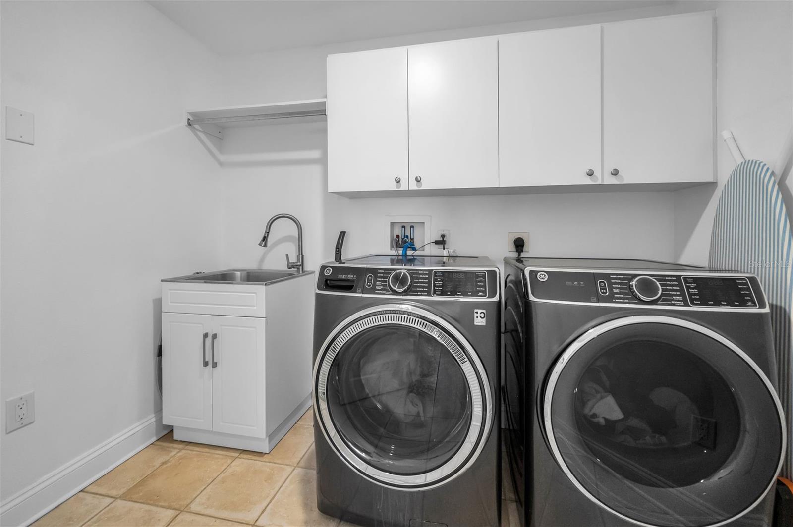 Great laundry room with utility sink and storage.