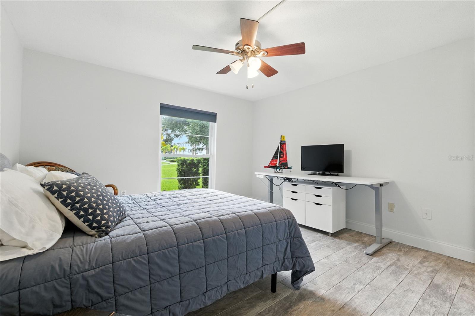 Spacious bedroom with a view of the landscape and shuffleboard courts