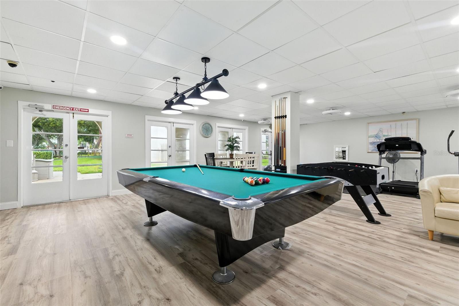 Game room area with pool table and foosball in the clubhouse